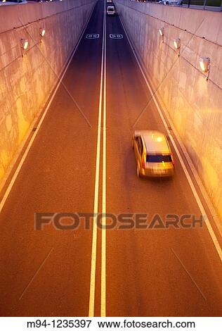 cars and motorcycles passing through a tunnel View Large Photo Image Stock Photo - cars and motorcycles passing through a tunnel. Fotosearch
