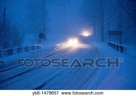 Cars circulating at bight over a frozen road, Myslakowice, Poland View Large Photo Image Stock Photo - Cars circulating at bight over a frozen road, Myslakowice, Poland. Fotosearch