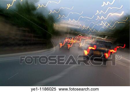 Cars moving on a highway as seen through a blurred windscreen, Paris, France. View Large Photo Image Stock Photography - Cars moving on a highway as seen through a blurred windscreen, Paris, France.. Fotosearch