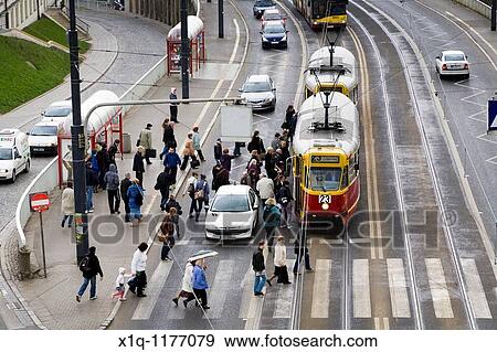 Cars, trams and people on Solidarity Avenue Aleja Solidarnosci, one of the main thoroughfares in Warsaw Poland View Large Photo Image Stock Photo - Cars, trams and people on Solidarity Avenue Aleja Solidarnosci, one of the main thoroughfares in Warsaw Poland. Fotosearch