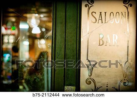 Carved and decorated glass door of a pub with the words Saloon, Bar and Pull in Hampstead, London, England, UK, Europe. View Large Photo Image Picture - Carved and decorated glass door of a pub with the words Saloon, Bar and Pull in Hampstead, London, England, UK, Europe.. Fotosearch