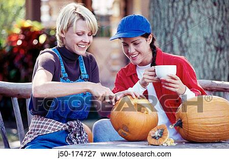 Stock Photo - Carving pumpkins. Fotosearch