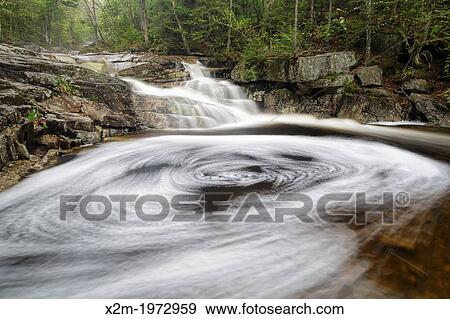 Cascade Brook during the spring months. This brook is located along the Basin-Cascades Trail in the Lincoln, New Hampshire USA. View Large Photo Image Stock Photo - Cascade Brook during the spring months. This brook is located along the Basin-Cascades Trail in the Lincoln, New Hampshire USA.. Fotosearch