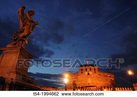 Stock Image - Castel Sant Angelothe Tiber River and Ponte Sant Angelo illuminated at dawn. Fotosearch