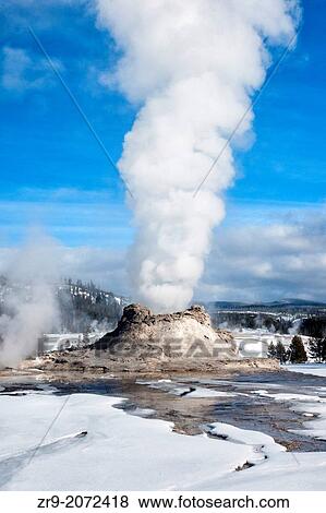 Castle Geyser erupting on a winter day at Yellowstone National Park, Wyoming, USA. View Large Photo Image Stock Photo - Castle Geyser erupting on a winter day at Yellowstone National Park, Wyoming, USA.. Fotosearch