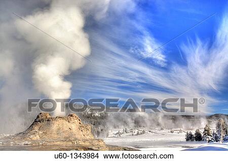 Castle Geyser erupts under a bright sky at Yellowstone National Park View Large Photo Image Picture - Castle Geyser erupts under a bright sky at Yellowstone National Park. Fotosearch