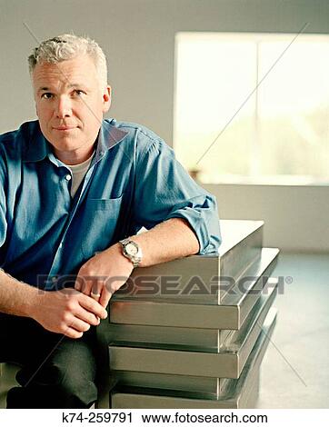 Casual Man In Denim Shirt Sitting In Chair View Large Photo Image Stock Image - Casual Man In Denim Shirt Sitting In Chair. Fotosearch