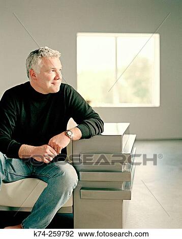 Casual Man Sitting On Chair Glancing Sideways View Large Photo Image Stock Image - Casual Man Sitting On Chair Glancing Sideways. Fotosearch
