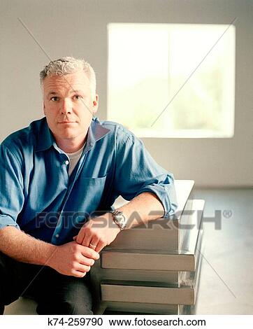 Stock Image - Casual Man Sitting On Chair. Fotosearch