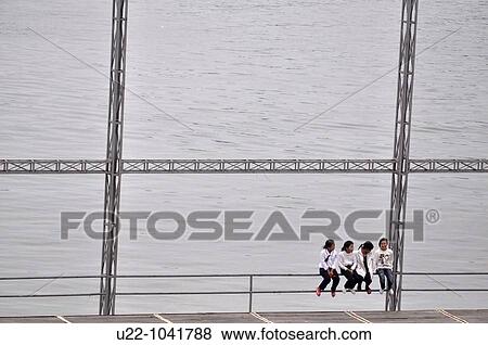 Cat Ba island (Vietnam): students hanging out at the Cat Ba town pier View Large Photo Image Stock Photo - Cat Ba island (Vietnam): students hanging out at the Cat Ba town pier. Fotosearch
