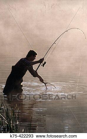Stock Image - Catching a fish. Fotosearch