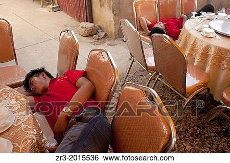 Caterering staff fall asleep before a buddhist wedding in a small village outside of Phnom Penh, Cambodia. View Large Photo Image Stock Photograph - Caterering staff fall asleep before a buddhist wedding in a small village outside of Phnom Penh, Cambodia.. Fotosearch