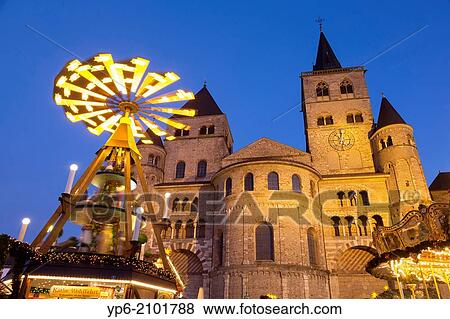 Stock Photo - Cathedral of Trier and Christmas market with pyramid at night, Trier, Germany.. Fotosearch