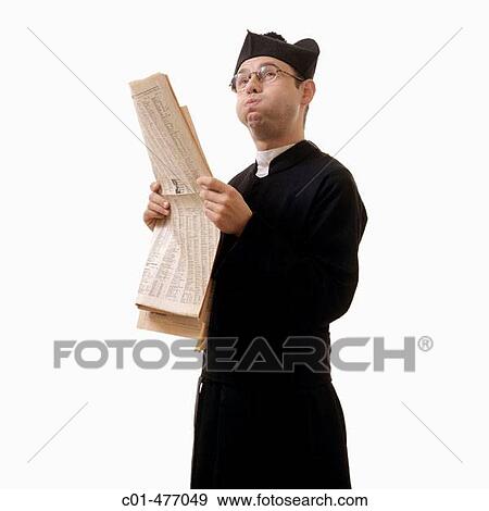 Catholic priest with a financial newspaper and looking upward View Large Photo Image Stock Photo - Catholic priest with a financial newspaper and looking upward. Fotosearch