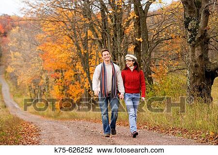 Stock Image - Caucasain couple, age 30's to 40? s, country, outdoors, road, autumn. Fotosearch