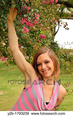 Caucasian 24 year old brown haired female model wearing pink and gray sweater with pink crepe myrtle View Large Photo Image Stock Photo - Caucasian 24 year old brown haired female model wearing pink and gray sweater with pink crepe myrtle. Fotosearch