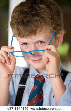 caucasian boy putting his glasses on View Large Photo Image Stock Image - caucasian boy putting his glasses on. Fotosearch