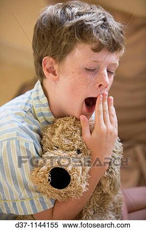Caucasian boy yawning in the bed View Large Photo Image Stock Photography - Caucasian boy yawning in the bed. Fotosearch