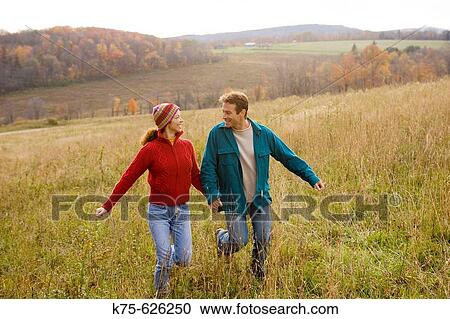 Caucasian couple, age 30's to 40? s, autumn, running, hills, outdoors View Large Photo Image Stock Image - Caucasian couple, age 30's to 40? s, autumn, running, hills, outdoors. Fotosearch