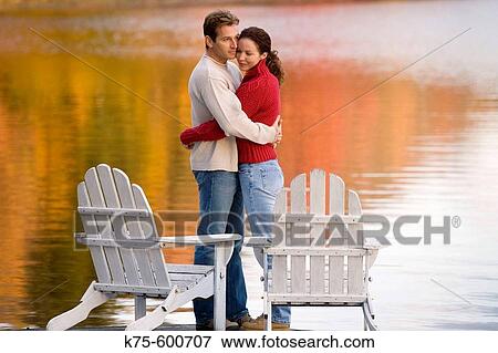 Caucasian couple, age 30's to 40? s, adirondack chairs, lake, autumn, reflection, hugging View Large Photo Image Stock Photo - Caucasian couple, age 30's to 40? s, adirondack chairs, lake, autumn, reflection, hugging. Fotosearch
