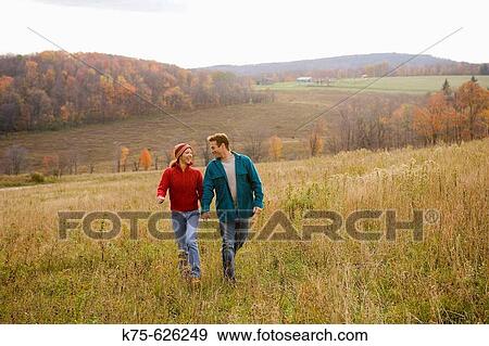 Caucasian couple, age 30's to 40? s, autumn, outdoors, country, hills, walking, happy View Large Photo Image Stock Photo - Caucasian couple, age 30's to 40? s, autumn, outdoors, country, hills, walking, happy. Fotosearch