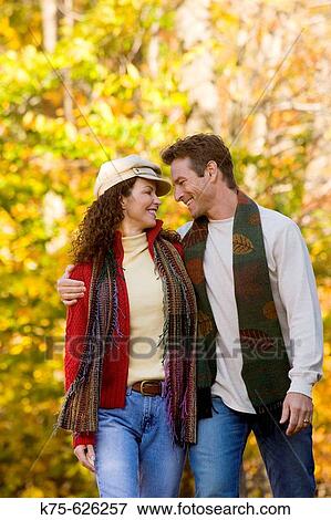 Caucasian couple, age 30's to 40? s, outdoors, country, autumn, hugging, smiling View Large Photo Image Stock Photo - Caucasian couple, age 30's to 40? s, outdoors, country, autumn, hugging, smiling. Fotosearch