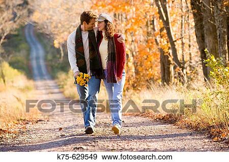Caucasian couple, age 30's to 40? s, autumn, country road, flowers, northeast USA View Large Photo Image Stock Photo - Caucasian couple, age 30's to 40? s, autumn, country road, flowers, northeast USA. Fotosearch