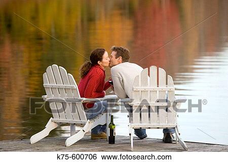 Caucasian couple, age 30's to 40? s, adirondack chairs, lake, reflection, autumn, kissing View Large Photo Image Stock Photograph - Caucasian couple, age 30's to 40? s, adirondack chairs, lake, reflection, autumn, kissing. Fotosearch