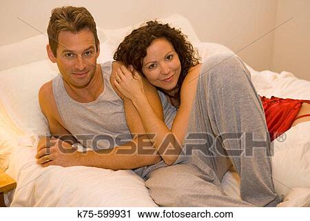 Caucasian couple, age 30's to 40's, bed, hugging View Large Photo Image Stock Image - Caucasian couple, age 30's to 40's, bed, hugging. Fotosearch