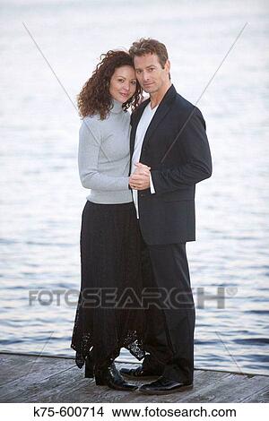 Caucasian couple, ages 30's to 40? s, romance, dock, lake View Large Photo Image Picture - Caucasian couple, ages 30's to 40? s, romance, dock, lake. Fotosearch
