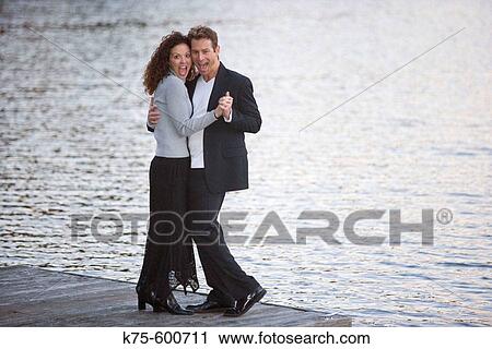 Caucasian couple, ages 30's to 40? s, dock, lake, laughing View Large Photo Image Stock Image - Caucasian couple, ages 30's to 40? s, dock, lake, laughing. Fotosearch