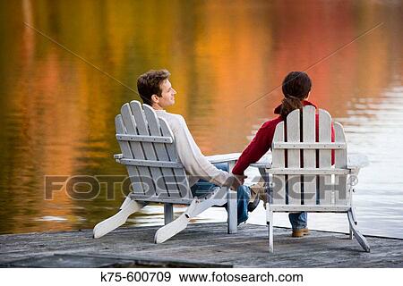 Caucasian couple, dock, age 30's to 40? s, adirondack chairs, lake, relfection, autumn View Large Photo Image Stock Photo - Caucasian couple, dock, age 30's to 40? s, adirondack chairs, lake, relfection, autumn. Fotosearch