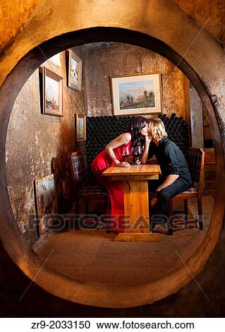 Caucasian couple in early twenties tasting red wine in one of the intimate niches at Muratie winery (1699), Winelands, Stellenbosch, Western Cape, South Africa. View Large Photo Image Stock Image - Caucasian couple in early twenties tasting red wine in one of the intimate niches at Muratie winery (1699), Winelands, Stellenbosch, Western Cape, South Africa.. Fotosearch
