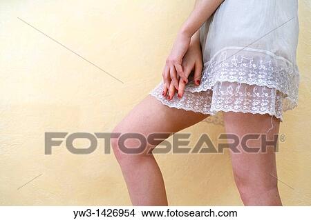 Picture - Caucasian female bare legs indoors. Fotosearch