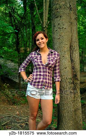 Caucasian female model eighteen year old red head against tree View Large Photo Image Stock Photography - Caucasian female model eighteen year old red head against tree. Fotosearch