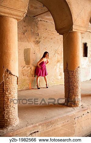 Caucasian female model wearing bright pink dress standing by columns of automobile tunnel in urban Memphis Tennessee USA. View Large Photo Image Stock Photograph - Caucasian female model wearing bright pink dress standing by columns of automobile tunnel in urban Memphis Tennessee USA.. Fotosearch