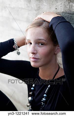 Caucasian girl holding her hair up with hands View Large Photo Image Stock Image - Caucasian girl holding her hair up with hands. Fotosearch