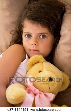 Caucasian girl hugging her teddy bear View Large Photo Image Stock Image - Caucasian girl hugging her teddy bear. Fotosearch