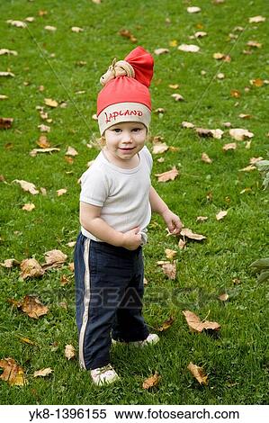 Caucasian Kid Girl in Red Hat Standing on Grass View Large Photo Image Stock Photography - Caucasian Kid Girl in Red Hat Standing on Grass. Fotosearch