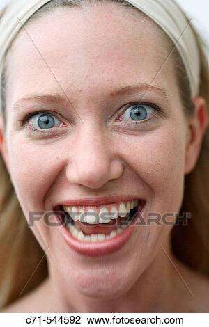 Stock Image - Caucasian woman mouth open looking into camera. Fotosearch