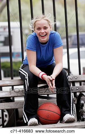 Stock Image - Caucasian woman on basketball court. Fotosearch