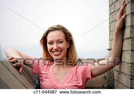 Caucasian woman smiling into camera View Large Photo Image Stock Photo - Caucasian woman smiling into camera. Fotosearch