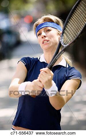 Caucasian woman tennis player swinging tennis racket View Large Photo Image Stock Photo - Caucasian woman tennis player swinging tennis racket. Fotosearch