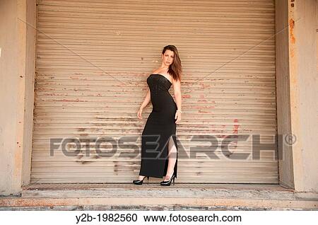 Caucasian woman wearing black dress standing in front of warehouse in urban Memphis Tennessee USA. View Large Photo Image Stock Image - Caucasian woman wearing black dress standing in front of warehouse in urban Memphis Tennessee USA.. Fotosearch