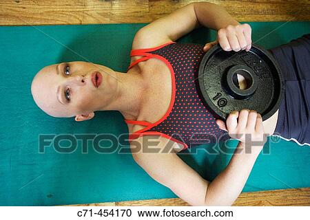 Caucasian Woman with alopecia areata/cancer survivor working out at the gym View Large Photo Image Stock Image - Caucasian Woman with alopecia areata/cancer survivor working out at the gym. Fotosearch