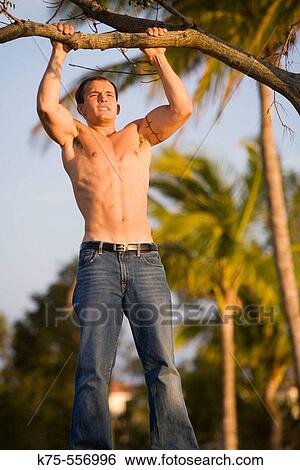 Caucasian young man pulling up View Large Photo Image Stock Photograph - Caucasian young man pulling up. Fotosearch