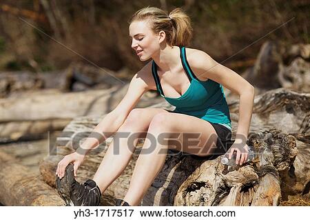 Caucasian young woman checking her injury after exercise View Large Photo Image Stock Photo - Caucasian young woman checking her injury after exercise. Fotosearch