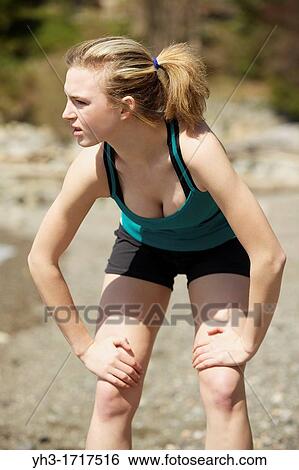Caucasian young woman resting after running on the beach View Large Photo Image Stock Photograph - Caucasian young woman resting after running on the beach. Fotosearch