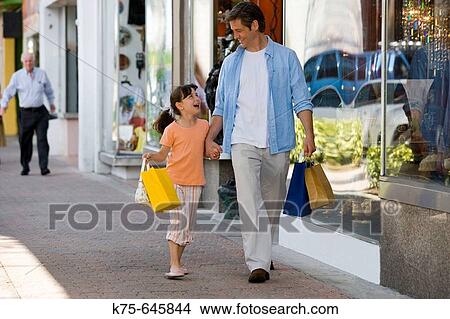 caucasians, dad, age 30 to 40, daughter, age 9, shopping, laughing, walking, hand in hand, happy View Large Photo Image Picture - caucasians, dad, age 30 to 40, daughter, age 9, shopping, laughing, walking, hand in hand, happy. Fotosearch