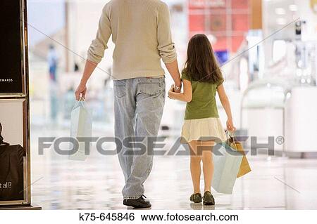 caucasians, dad, age 30 to 40, daughter, age 9, shopping, department store, mall, hand in hand View Large Photo Image Stock Photograph - caucasians, dad, age 30 to 40, daughter, age 9, shopping, department store, mall, hand in hand. Fotosearch